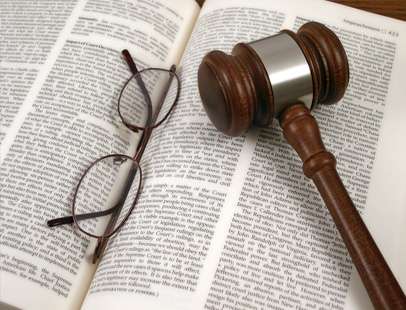 Gavel and glasses on top of a book
